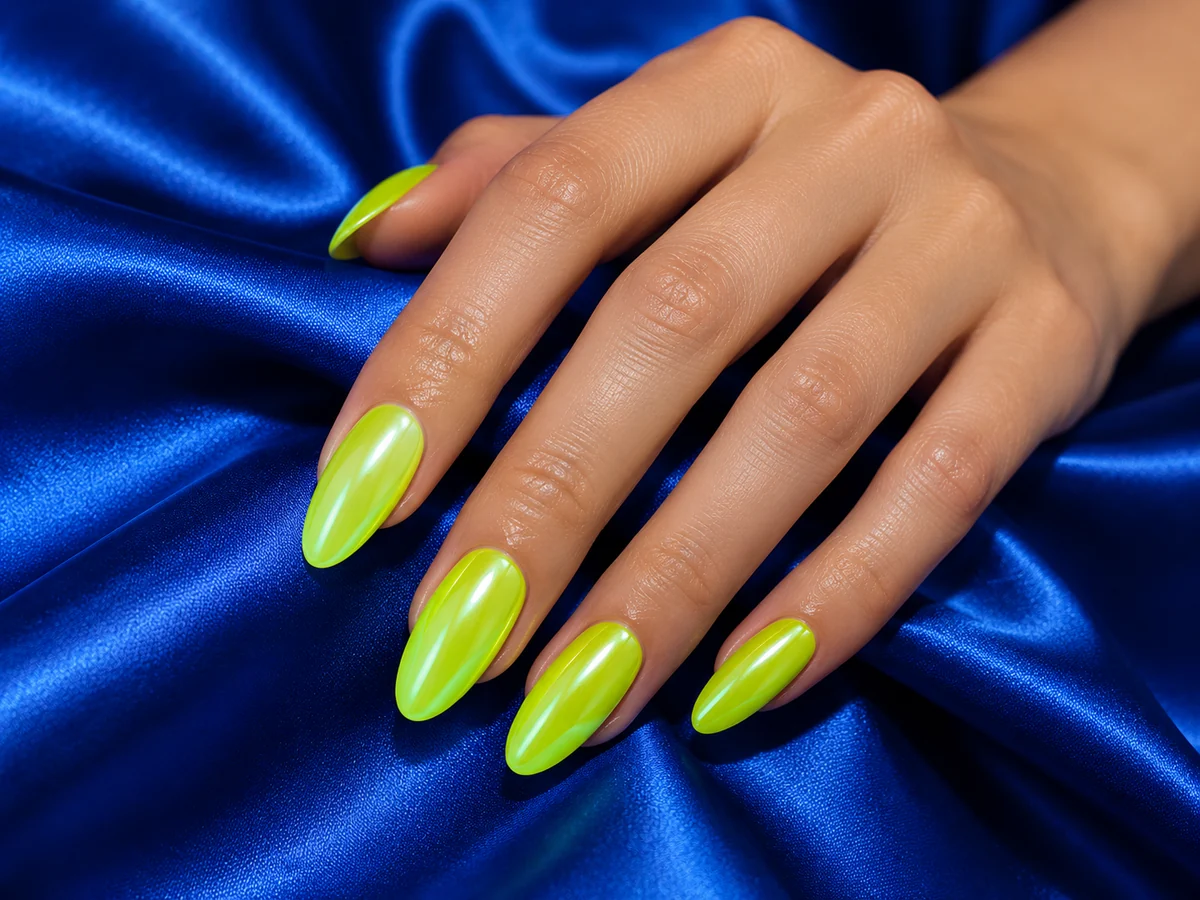 Neon lime nails against blue satin